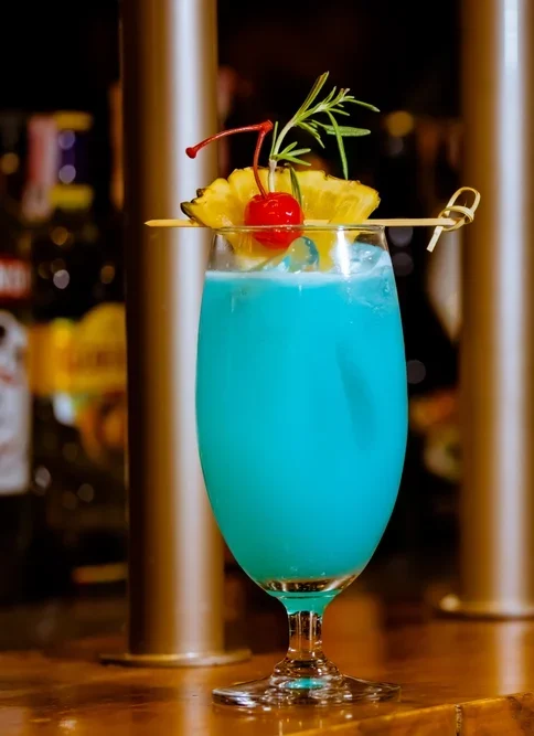 Blue Hawaiian cocktail served over ice, featuring rum, blue curaçao, pineapple juice, and coconut cream—crafted by a mobile trailer bar for vibrant summer events.