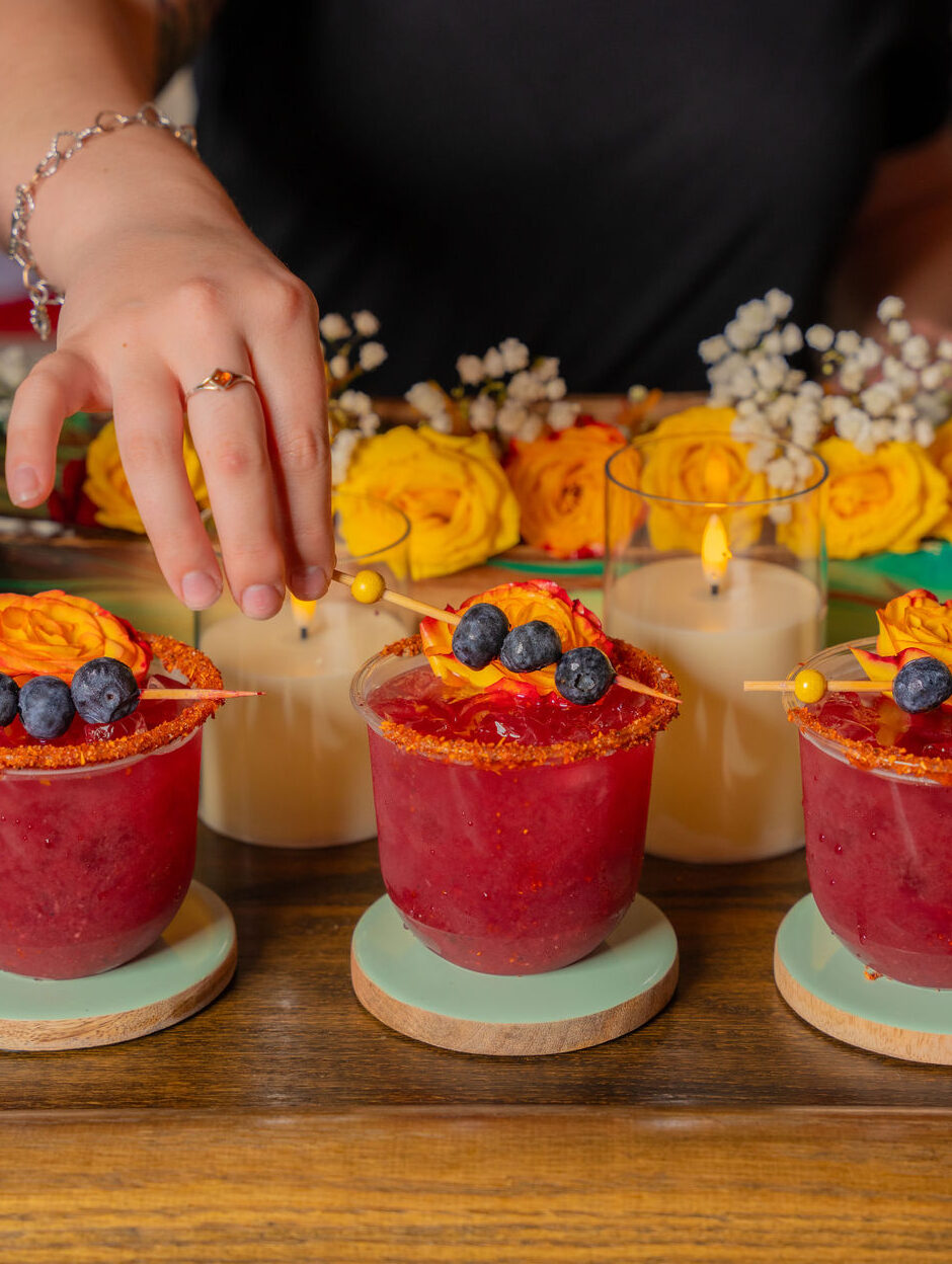 Blueberry Passion Fruit mocktail served over ice, featuring fresh blueberries, passion fruit juice, and a touch of citrus, made by a mobile bar service.