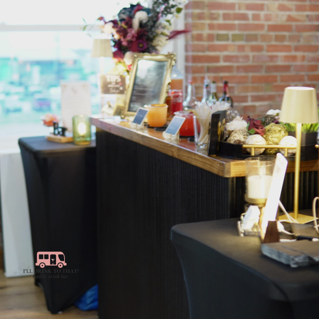 Modern black portable bar with wood countertop, cocktail display, and upscale decor for Houston wedding reception