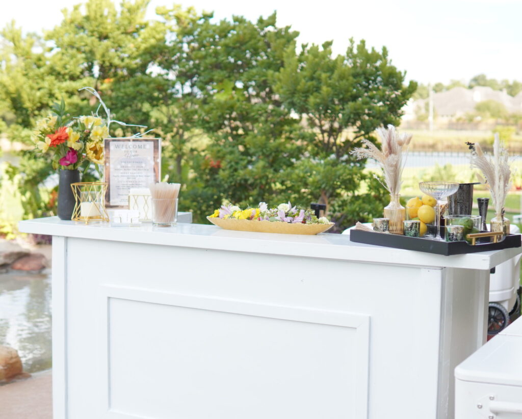 One of our Elegant white mobile bar setups for Houston wedding with fresh cocktail ingredients