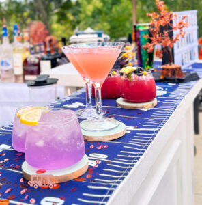 Football theme mobile bar event in Houston with lavender gin cocktail, cosmo, blackberry mocktail, and acrylic cups by I’ll Drink To That!