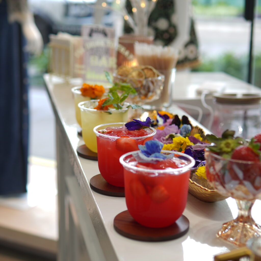 Colorful signature cocktails displayed on a styled Houston mobile bar