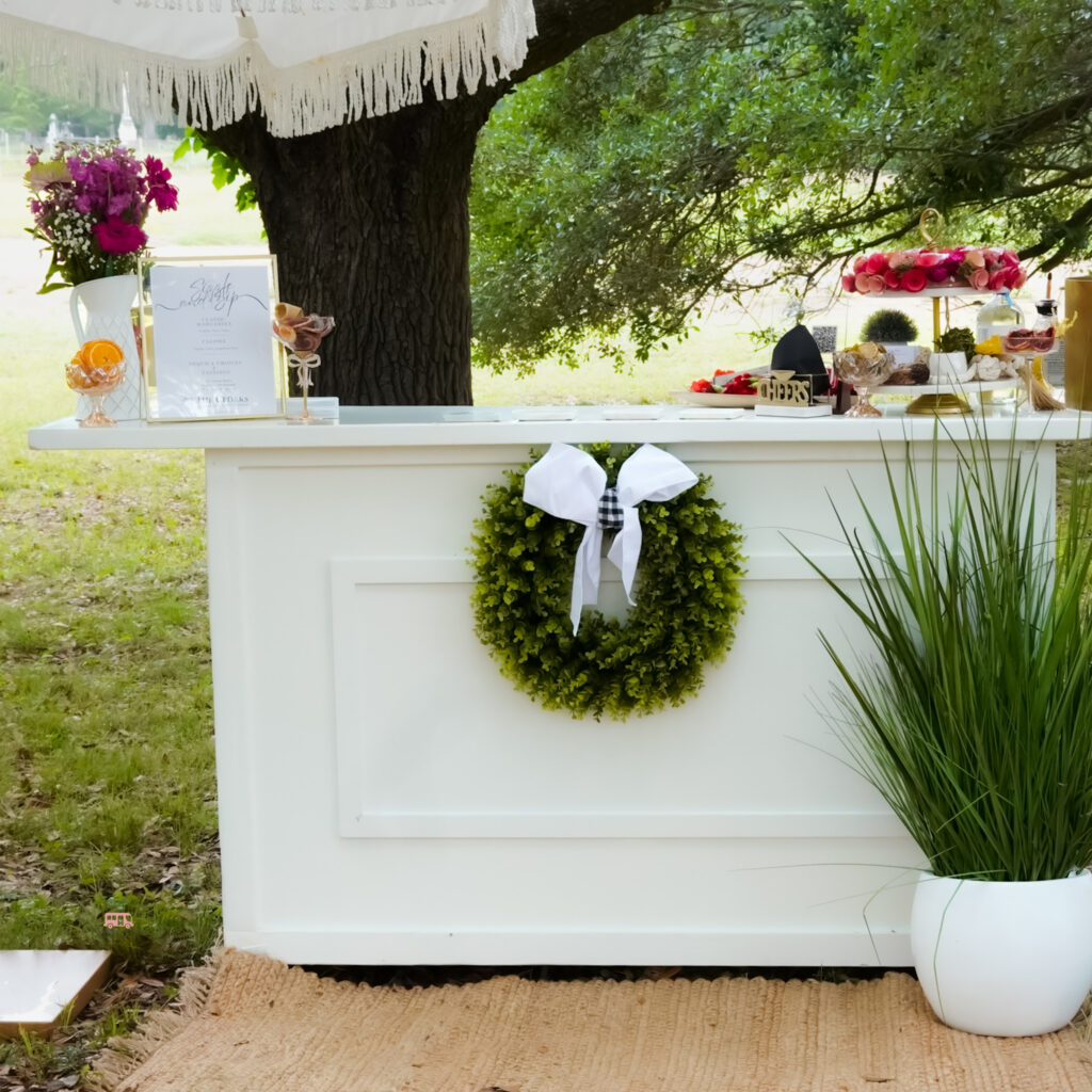 White mobile bar styled for a Houston community event
