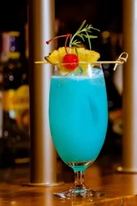 Blue Hawaiian cocktail served over ice, featuring rum, blue curaçao, pineapple juice, and coconut cream—crafted by a mobile trailer bar for vibrant summer events.