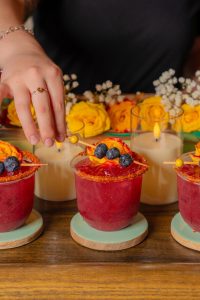 Blueberry Passion Fruit mocktail served over ice, featuring fresh blueberries, passion fruit juice, and a touch of citrus, made by a mobile bar service.