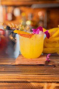 Vibrant Mango Joy mocktail served over ice with fresh mango juice, lemon, and simple syrup—crafted by a mobile bartending service.