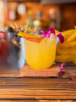 Vibrant Mango Joy mocktail or cocktail served over ice with fresh mango juice, lemon, and simple syrup—crafted by a mobile bartending service.